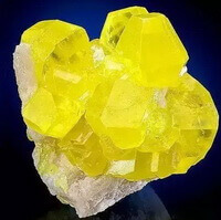 yellow mineral crystal blocks of Natural sulfur attach on rocks