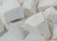 whitish herb blocks of Malt Sugar in irregular shapes are piled together