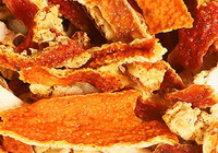 Dried orange-colored slices and pieces of Tangerine Peel