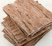 dried brownish herb square pieces of Eucommia Bark are piled together