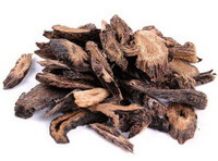 brownish dried root slices of Herba Cistanchis are piled together