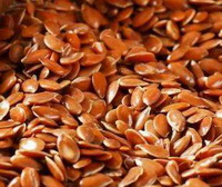brown grains of flaxseed are piled together