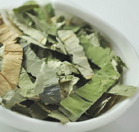 lotus leaf tea herb pieces are piled in a small plate