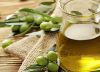 yellow olive oil and some green olive fruit berries
