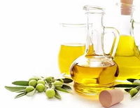 several bottles of olive oil and green olive fruit berries